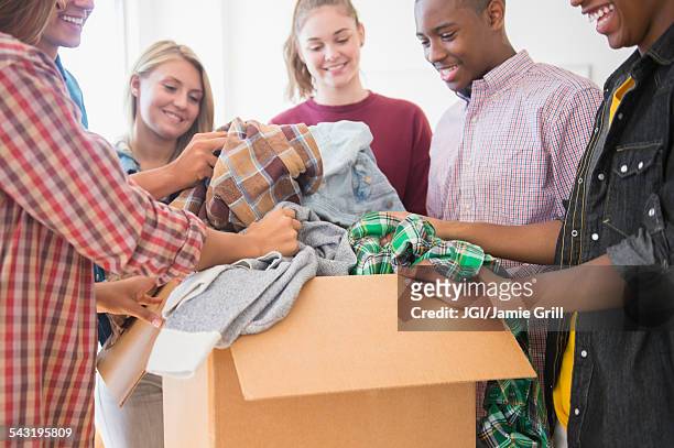 teenagers donating clothes to charity - clothing donation stock pictures, royalty-free photos & images