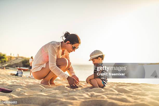 lets make a sand castle - hot babe stock pictures, royalty-free photos & images