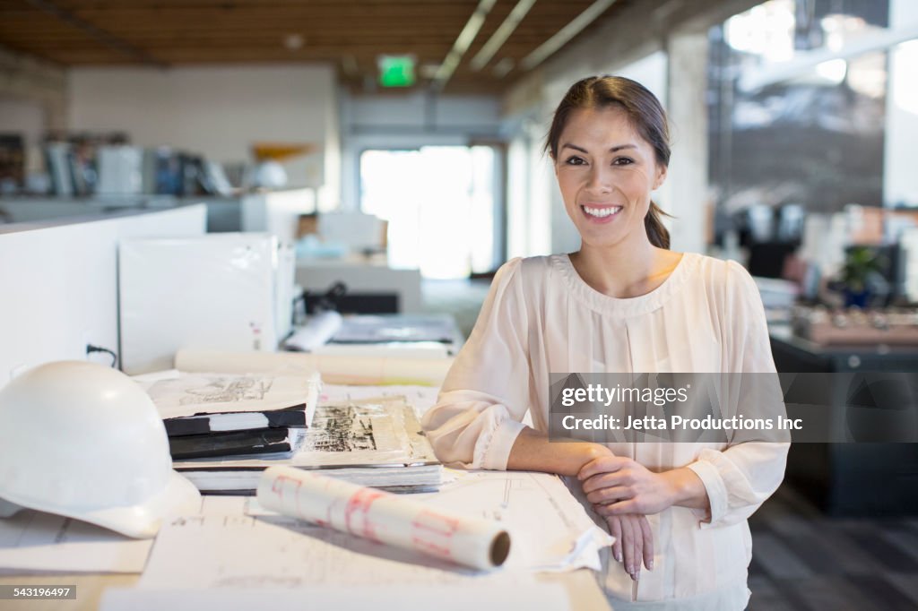 Mixed race businesswoman smiling in office