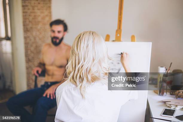 blonde artist taking skatches of her handsome model - lay figure stock pictures, royalty-free photos & images