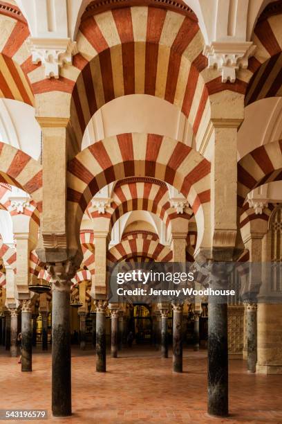 ornate arches in mosque, cordoba, andalusia, spain - cordoba mosque stock-fotos und bilder