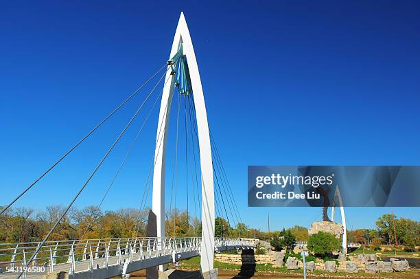 keeper of the plains suspension bridge and statue - wichita stock pictures, royalty-free photos & images