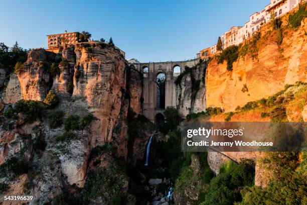 bridge and buildings on sheer cliffs, ronda, andalusia, spain - ronda fotografías e imágenes de stock