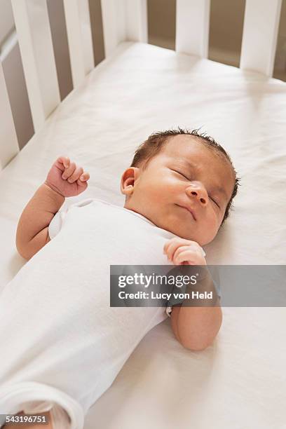 mixed race baby sleeping in crib - lying on back stock pictures, royalty-free photos & images