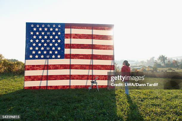 caucasian girl admiring american flag in field - rural ontario canada stock pictures, royalty-free photos & images