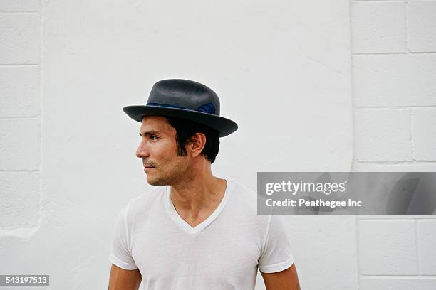 mixed race man wearing hat outdoors - man hat stock pictures, royalty-free photos & images