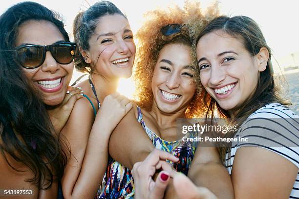 smiling women taking selfie together outdoors - la four stock pictures, royalty-free photos & images