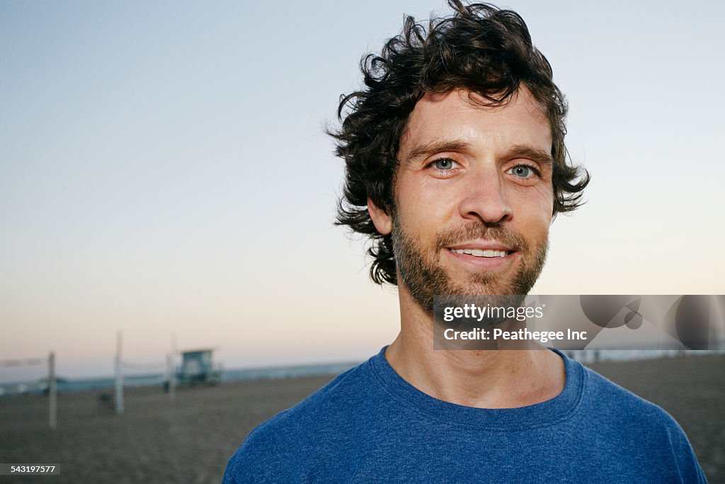 Caucasian man smiling on beach