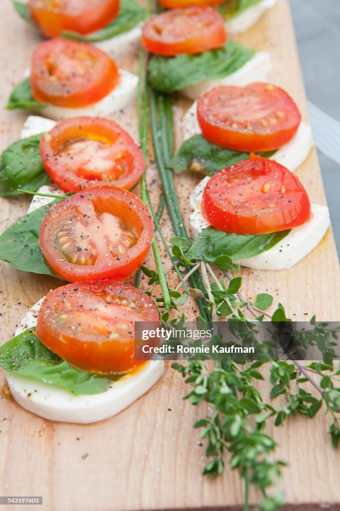 Close up of fresh tomato, cheese and herb salad