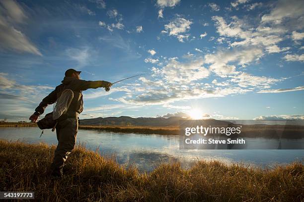 fisherman casting in river - ketchum idaho stock-fotos und bilder