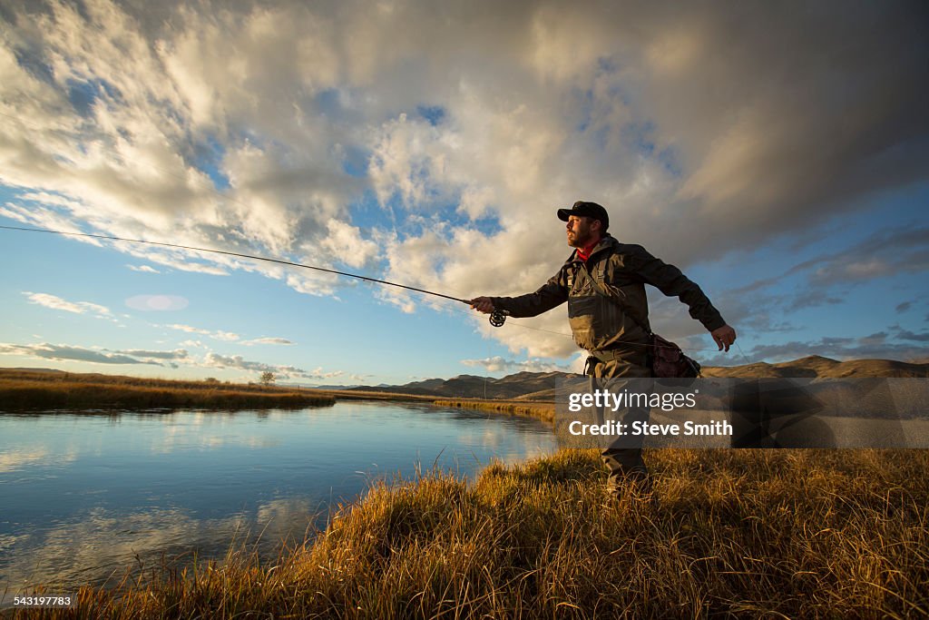 Fisherman casting in river
