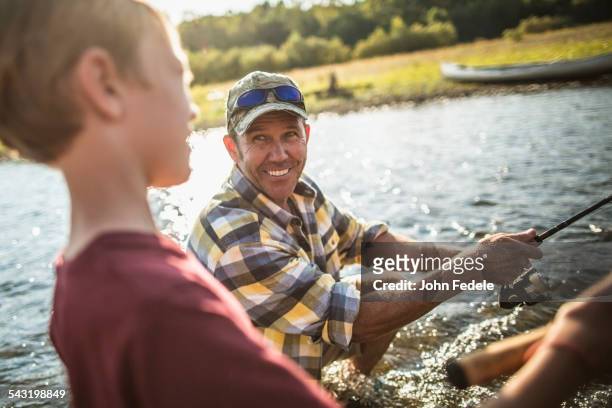 caucasian father and son fishing in river - missouri mittlerer westen stock-fotos und bilder