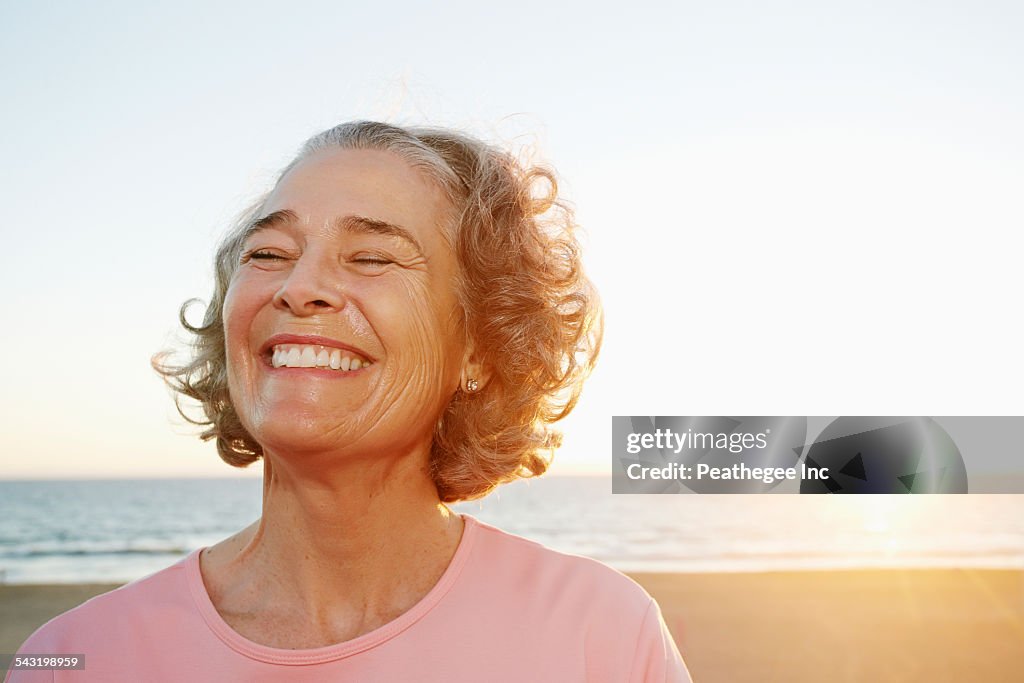 Caucasian woman smiling at beach