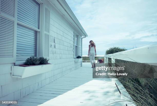 caucasian woman walking on porch - ハンプトン ストックフォトと画像