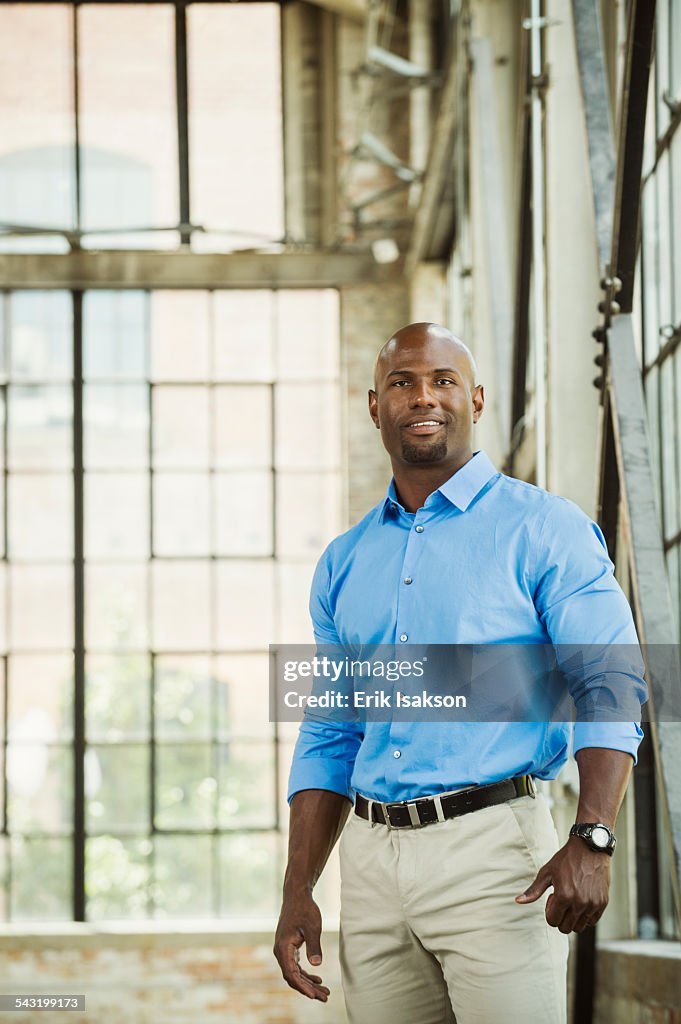 Black businessman smiling in warehouse