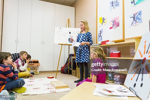 girl giving presentation to classmates - montessori education stock-fotos und bilder