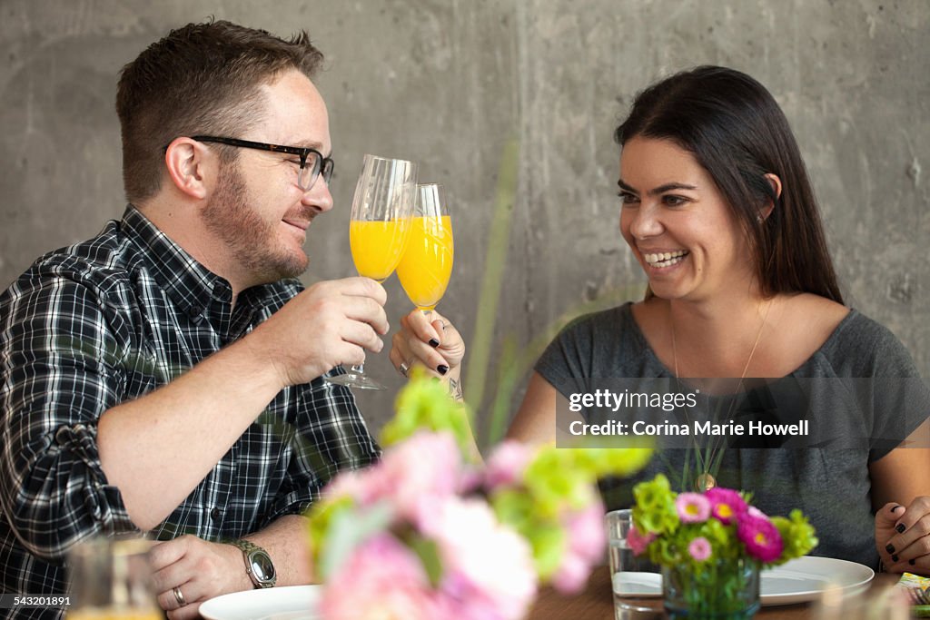 Man and woman clinking glasses