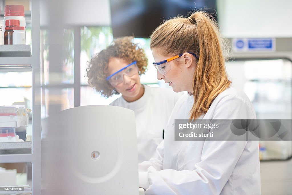 Female scientists with centrifuge