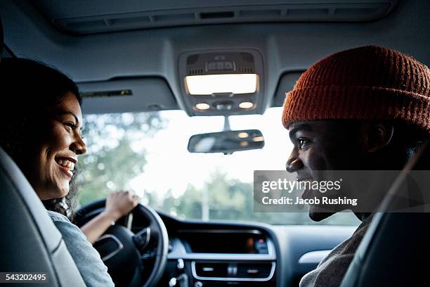 young couple chatting in front seat of car - couple with car stock-fotos und bilder