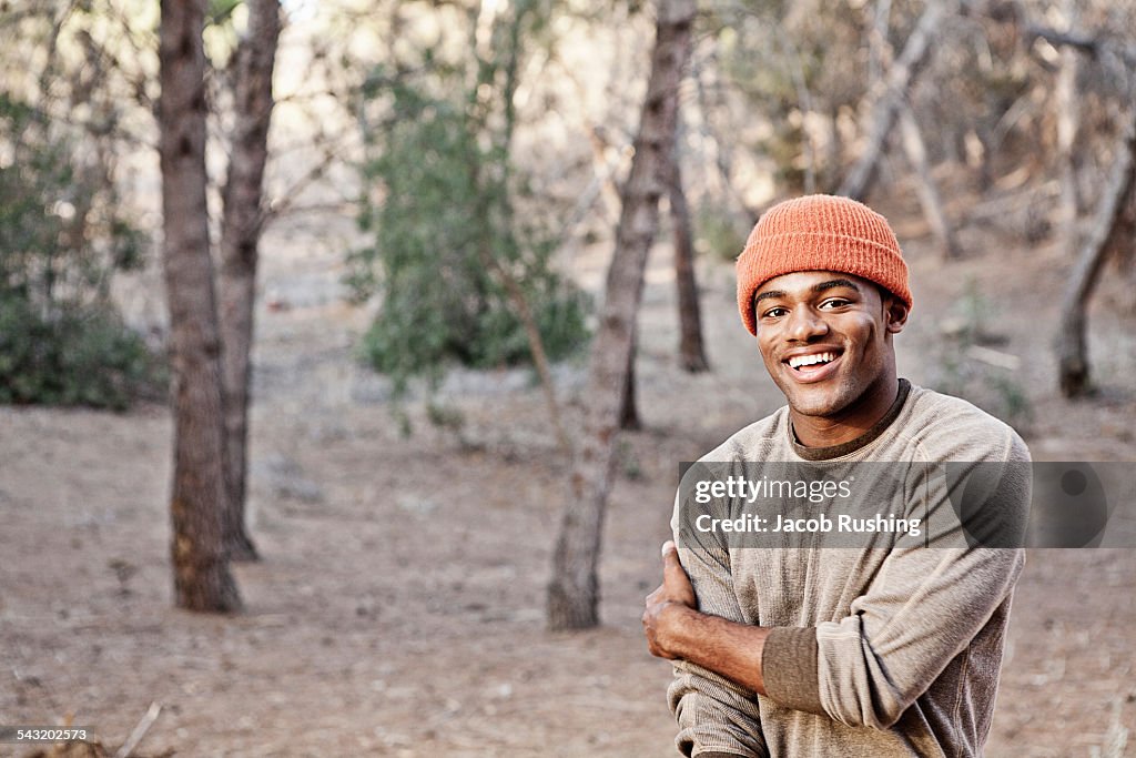 Portrait of smiling young man in forest