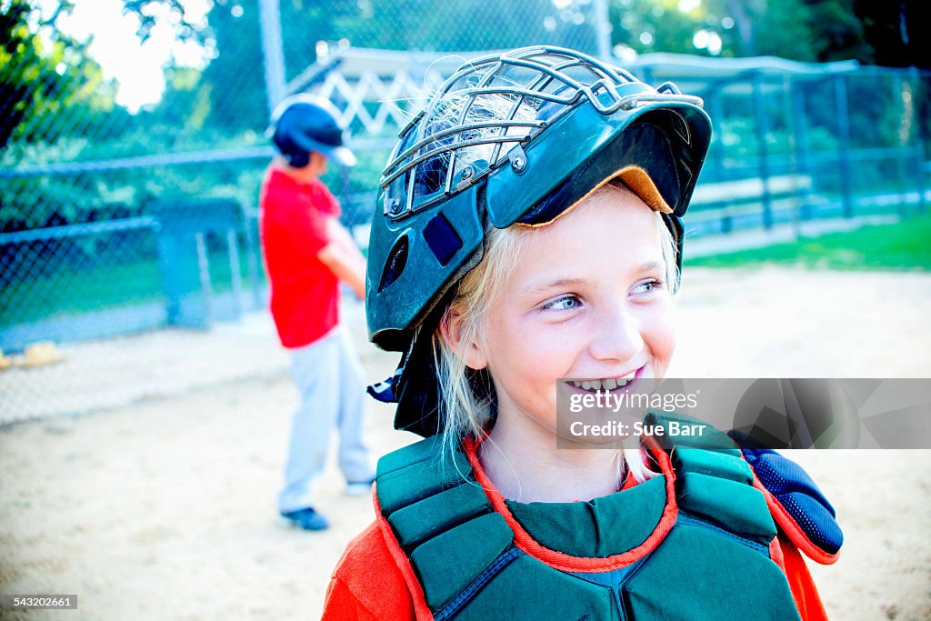 Young girl wearing baseball kit