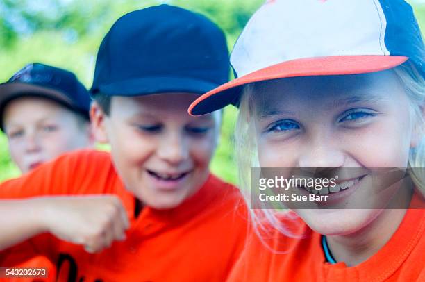 young baseball players fooling around - girl baseball cap stock pictures, royalty-free photos & images