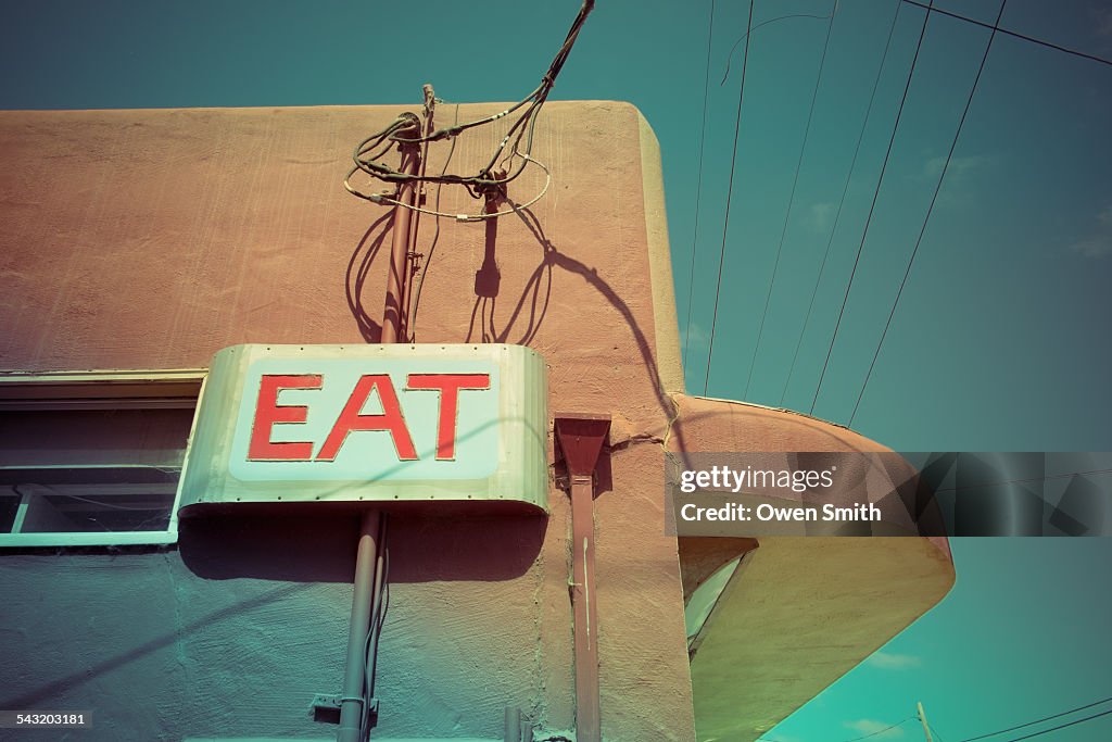 Low angle view of eat sign on cafe wall, Pescardero, California, USA