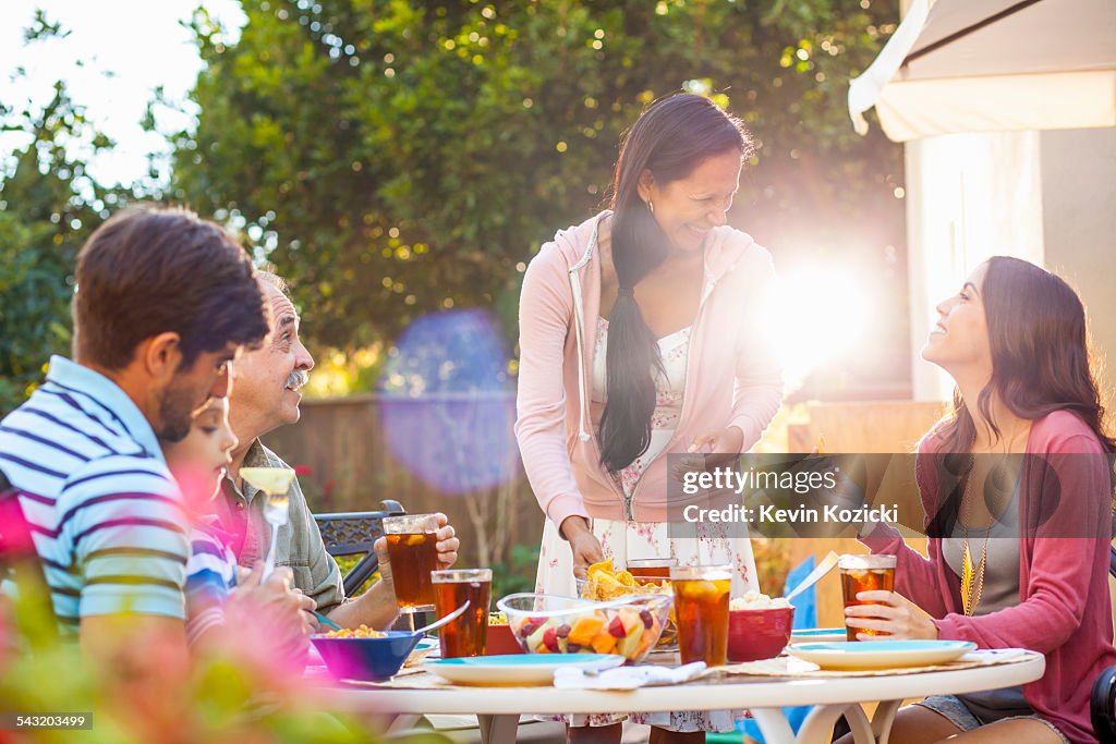 Three generation family dining in garden