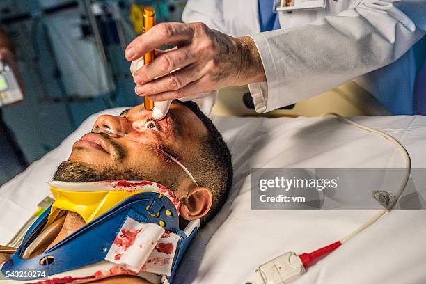injured young man in er - cornea stock pictures, royalty-free photos & images
