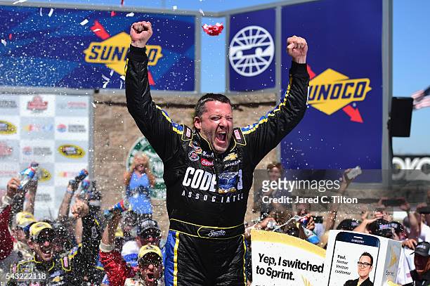 Tony Stewart, driver of the Code 3 Assoc/Mobil 1 Chevrolet, celebrates in victory lane after winning the NASCAR Sprint Cup Series Toyota/Save Mart...