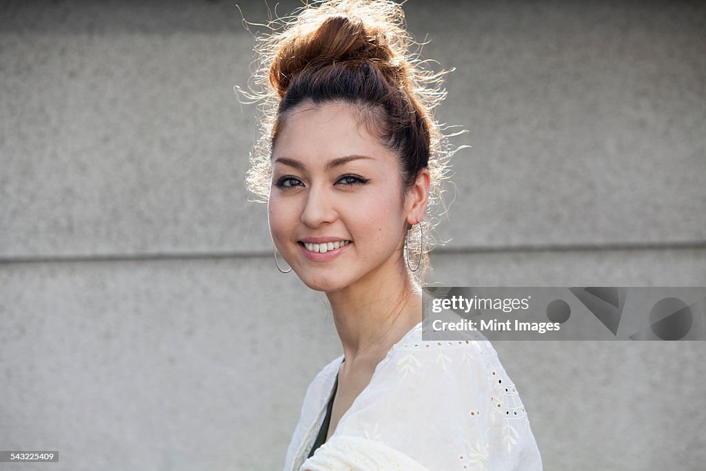 A smiling woman standing outdoors.