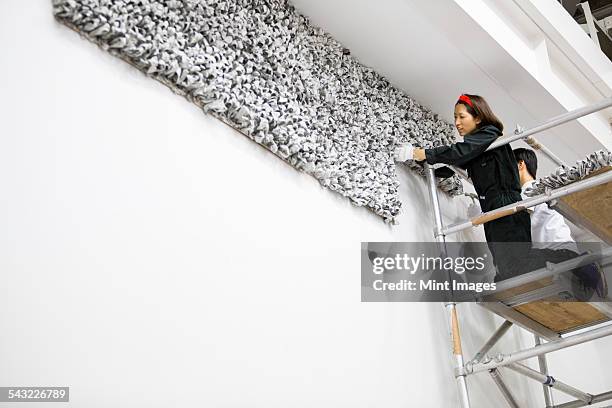 an artist at work in a studio. - installationskunst stock-fotos und bilder