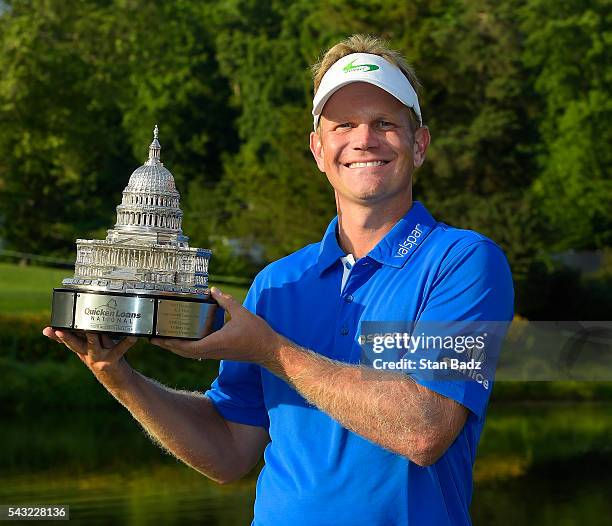 Billy Hurley III pose with the trophy after the final round of the Quicken Loans National at Congressional Country Club on June 26, 2016 in Bethesda,...