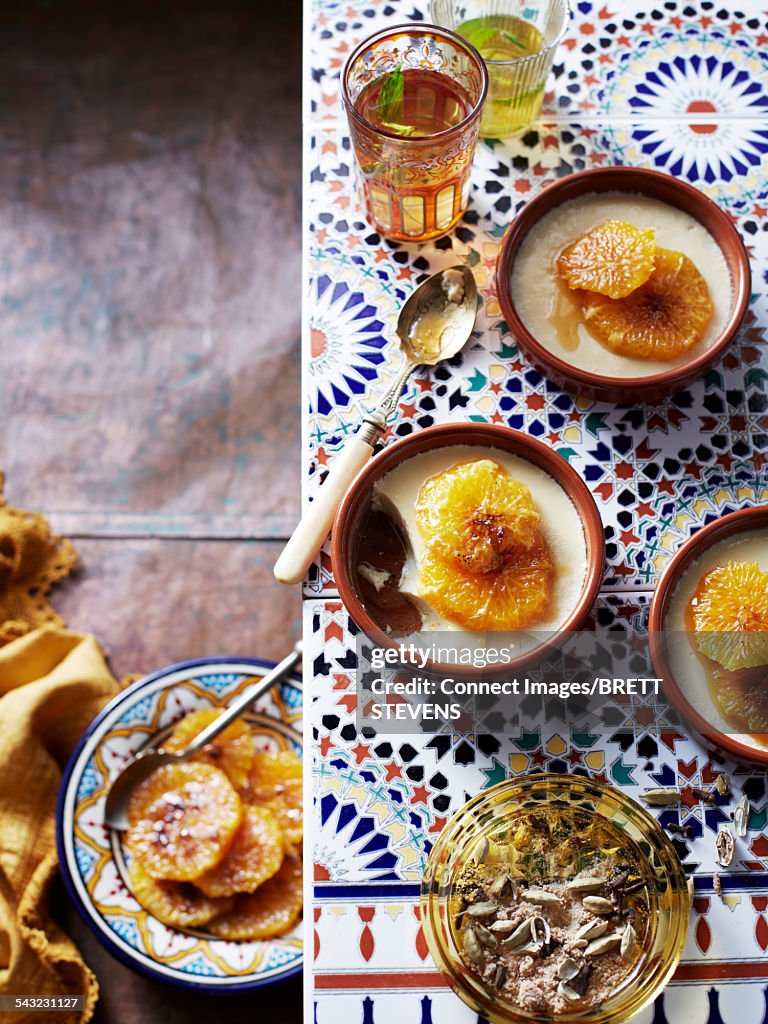 Still life of cardamom custard and caramelized oranges