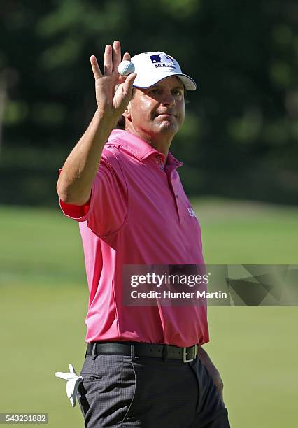 Billy Andrade waves to the crowd after finishing his round on the 18th hole during the final round of the Champions Tour American Family Insurance...