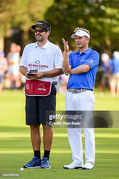 Billy Hurley III checks yardage with his caddie on the 18th hole fairway during the final round of the Quicken Loans National at Congressional...