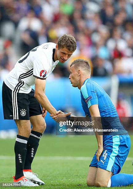 Thomas Mueller of Germany reacts with Jan Durica of Slovakia during the UEFA EURO 2016 round of 16 match between Germany and Slovakia at Stade...