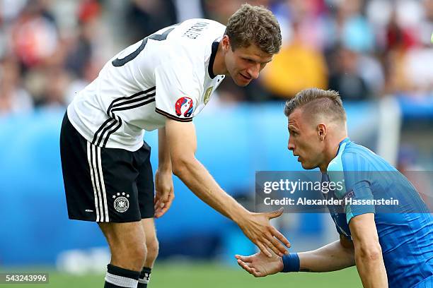 Thomas Mueller of Germany reacts with Jan Durica of Slovakia during the UEFA EURO 2016 round of 16 match between Germany and Slovakia at Stade...