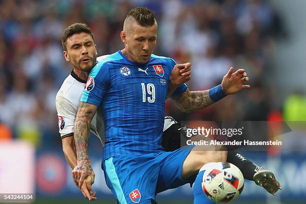 Jonas Hector of Germany battles for the ball with Juraj Kucka of Slovakia during the UEFA EURO 2016 round of 16 match between Germany and Slovakia at...