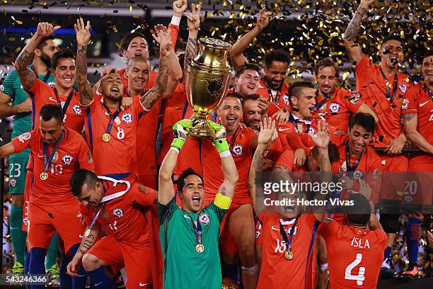 Claudio Bravo goalkeeper of Chile lifts the trophy after winning the championship match between Argentina and Chile at MetLife Stadium as part of...