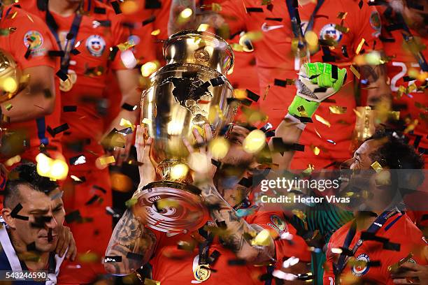 Jose Pedro Fuenzalida of Chile celebrates with the trophy after winning the championship match between Argentina and Chile at MetLife Stadium as part...