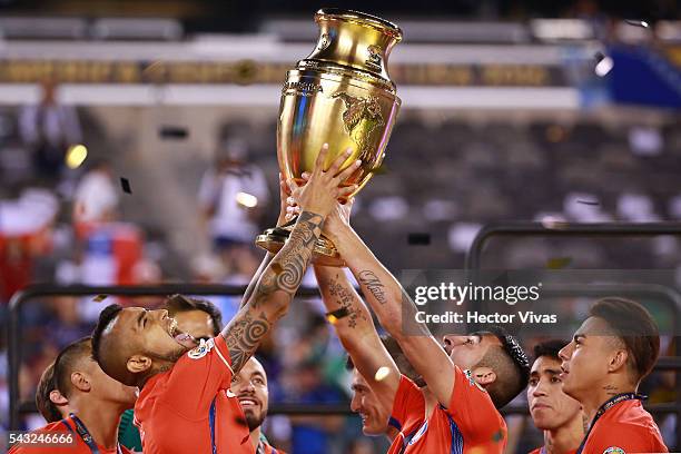 Arturo Vidal and Mauricio Isla of Chile celebrate with the trophy after winning the championship match between Argentina and Chile at MetLife Stadium...