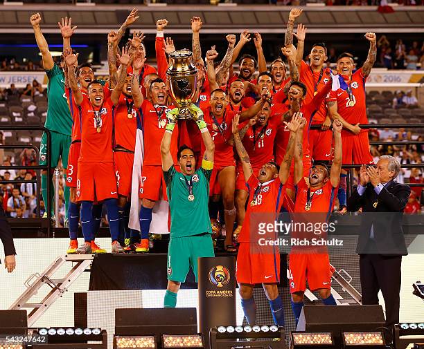 Claudio Bravo of Chile celebrates with teamamtes while lifting the trophy after winning the championship match between Argentina and Chile at MetLife...