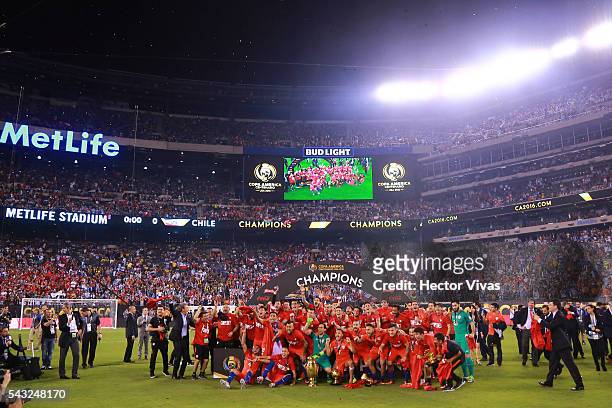 Players of Chile celebrate with the trophy after winning the championship match between Argentina and Chile at MetLife Stadium as part of Copa...