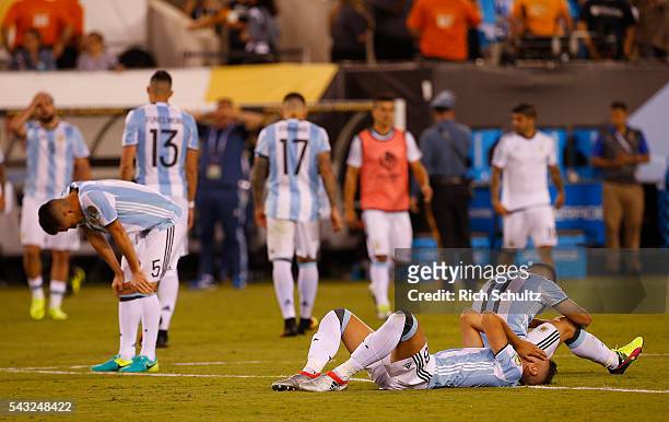 Matias Kranevitter, Erik Lamela and Sergio Aguero look dejected after losing in penalty kicks the championship match between Argentina and Chile at...