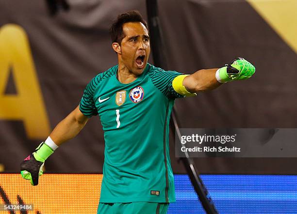 Claudio Bravo of Chile celebrates after saving a penalty shot by Lucas Biglia of Argentina during the championship match between Argentina and Chile...