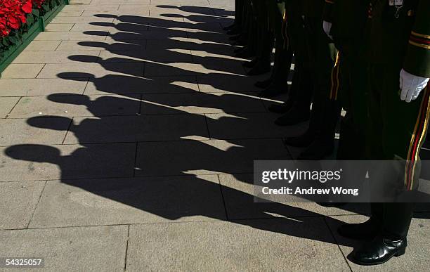 Chinese soldiers stand next to the Monument to the People's Heroes during a memorial ceremony at Tiananmen Square to mark the defeat of Japan 60...