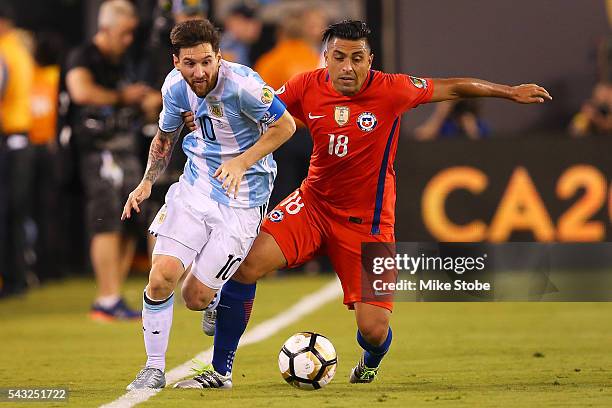 Gonzalo Jara of Chile and Lionel Messi of Argentina vie for the bal during the Copa America Centenario Championship match at MetLife Stadium on June...