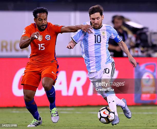 Lionel Messi of Argentina takes the ball as Jean Beausejour of Chile defends during the Copa America Centenario Championship match at MetLife Stadium...