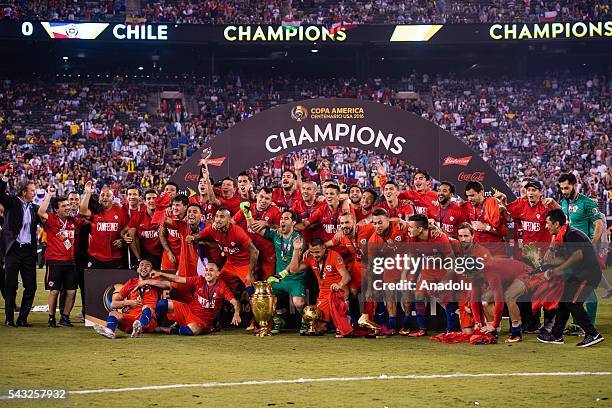 Players of Chile celebrate with the trophy after the championship match between Argentina and Chile at MetLife Stadium as part of Copa America...